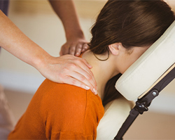 Woman getting her neck adjusted by a chiropractor