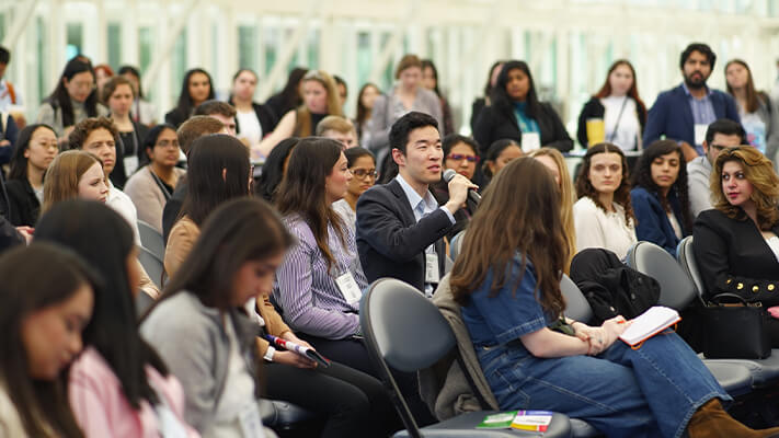 Attendee asking a question during a question and answer session at the Annual Meeting