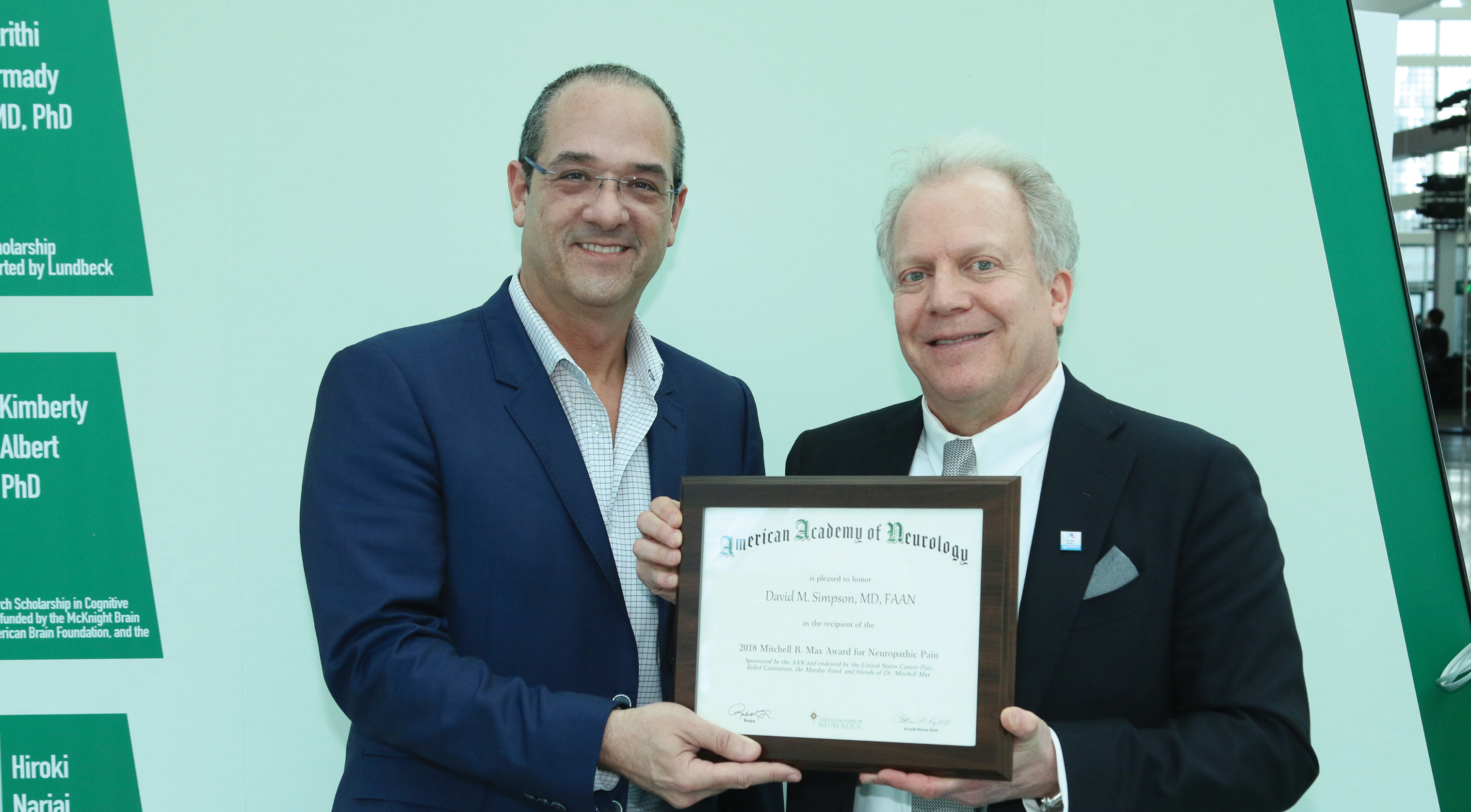 David M. Simpson, MD, FAAN, receives an award at the 2018 AAN Annual Meeting