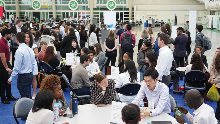 Large group of attendees networking while sitting and standing
